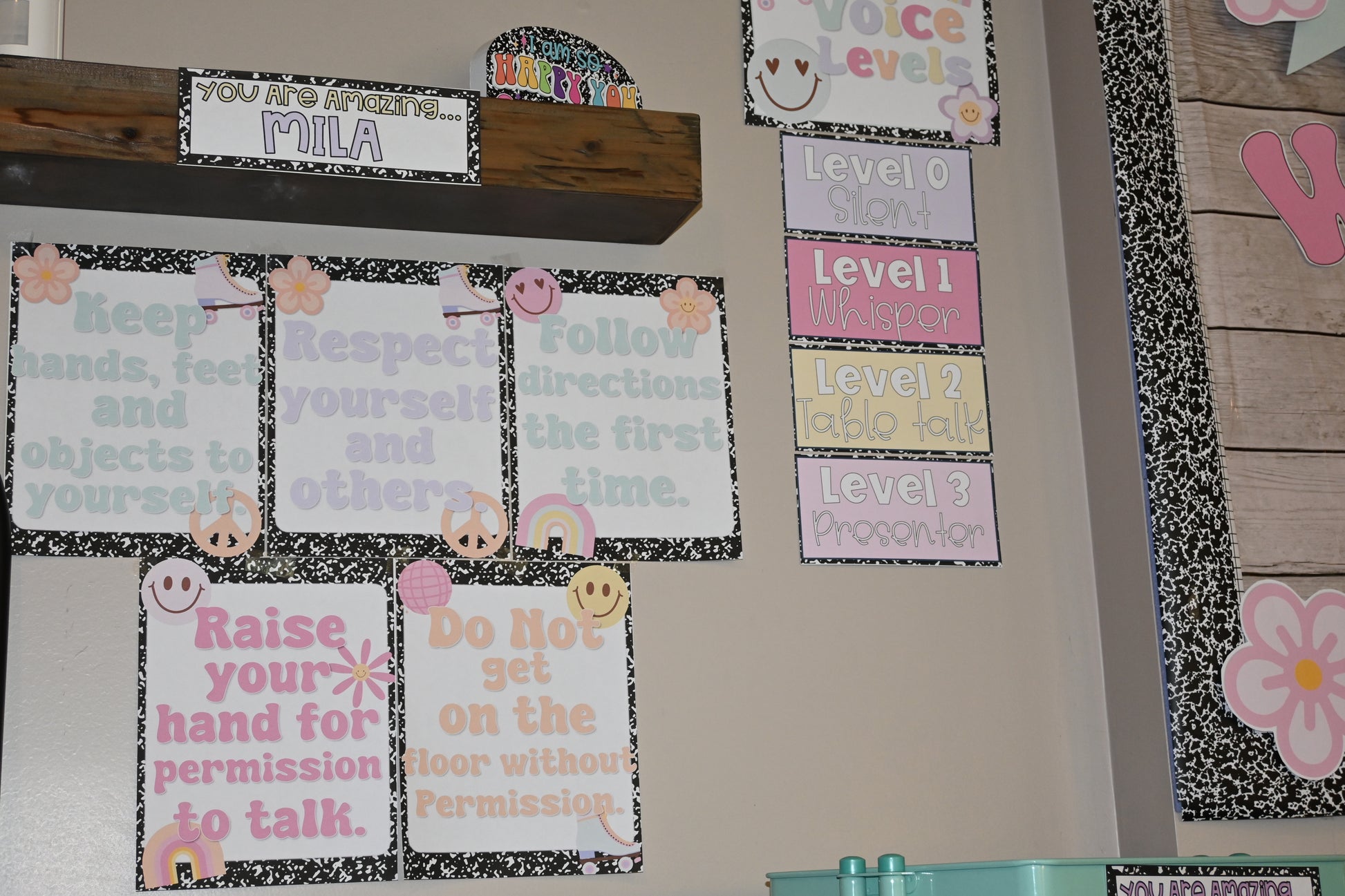 Educational posters on a classroom wall with behavioral guidelines and decorations.