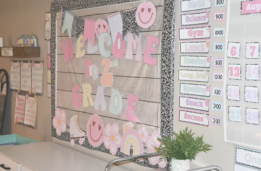 Educational classroom setup with a 'Welcome to 2nd Grade' banner and various educational materials on the wall.