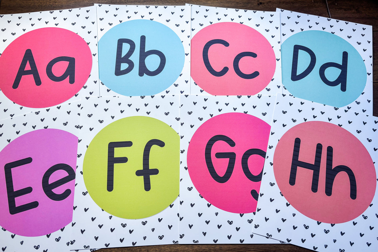 Colorful alphabet flashcards on a white background with black heart patterns